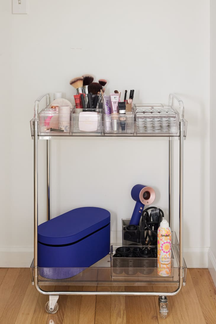 The Home Edit clear cart for storage stocked with miscellaneous bath items