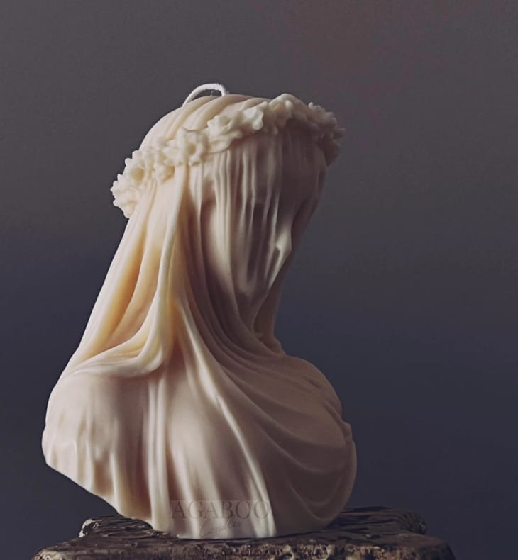 A candle of the bust of a veiled lady