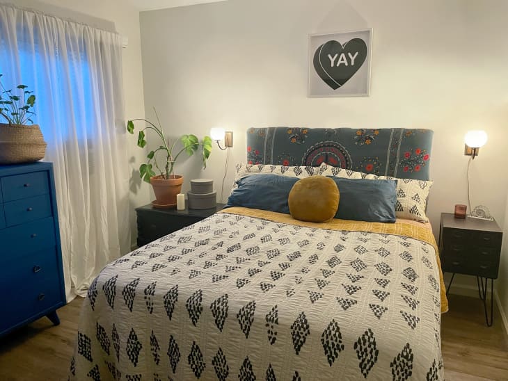 A bedroom with a blue and white bohemian duvet