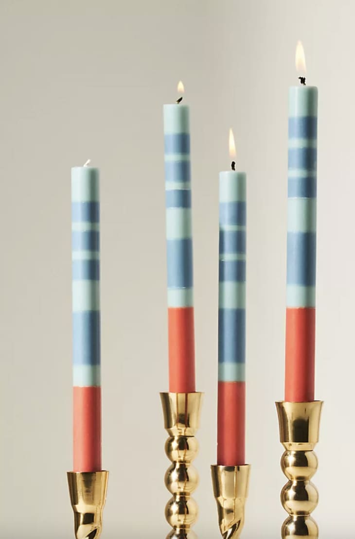 Blue and red taper candles in gold candle holders