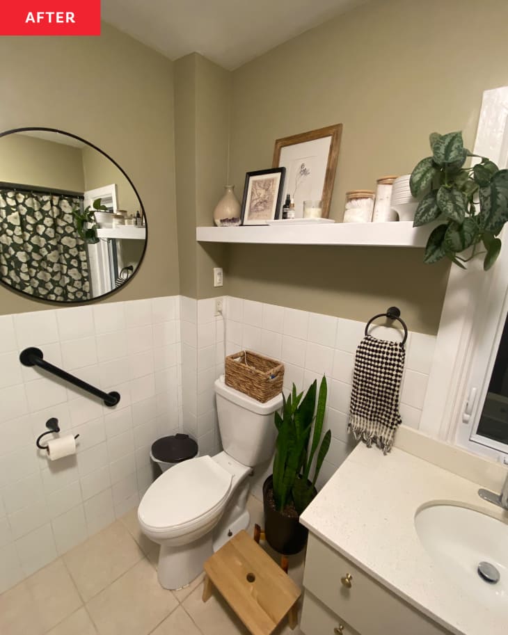 Newly renovated bathroom with beige colored walls and black and white checkerboard hand towel hanging near sink.