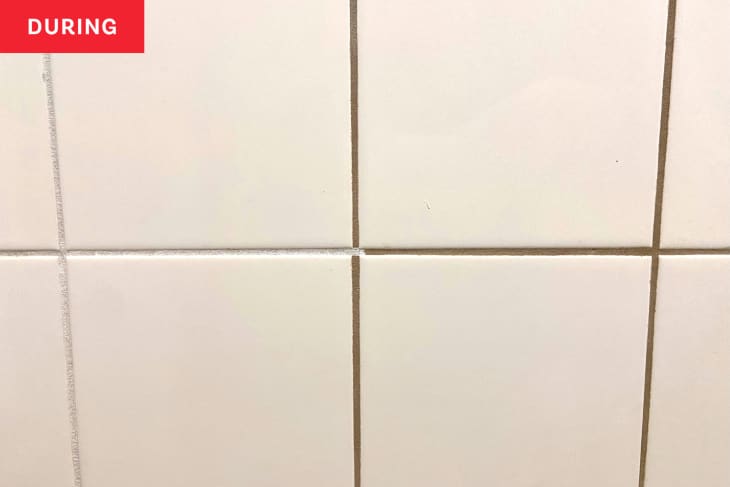 Tiles during renovation;  left side with white grout and right side with grey grout.