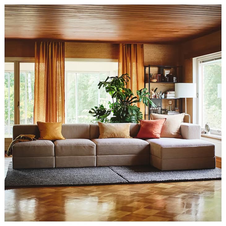 Ikea Jattebo sofa in wood paneled room.