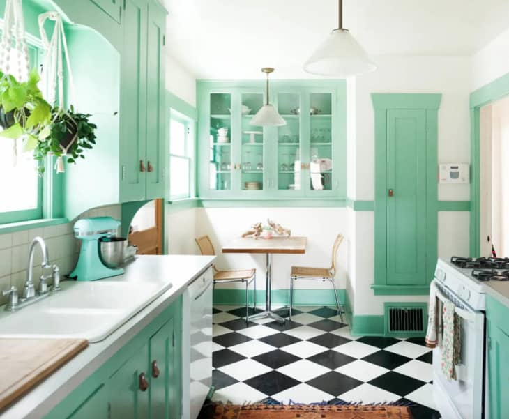 black and white checkered tile floor with mint green and white kitchen accents