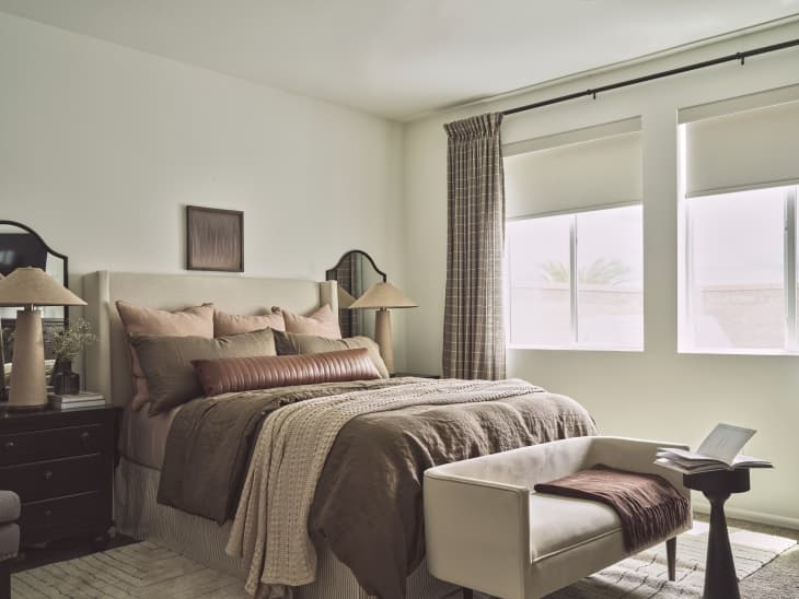 Light neutral painted bedroom with brown, taupe bedding.