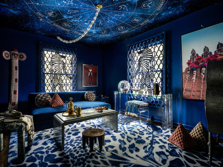 Dark blue painted living room with astrology chart on ceiling.
