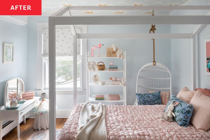 pink textured comforter, white slated hanging chair, bunny stuffed animal, white book shelf, child's vanity, 4 poster bed, pok-a dot roman shades, light blue walls, canopy bed, wood floors, pink rug, yellow bird and cloud wallpaper on ceiling