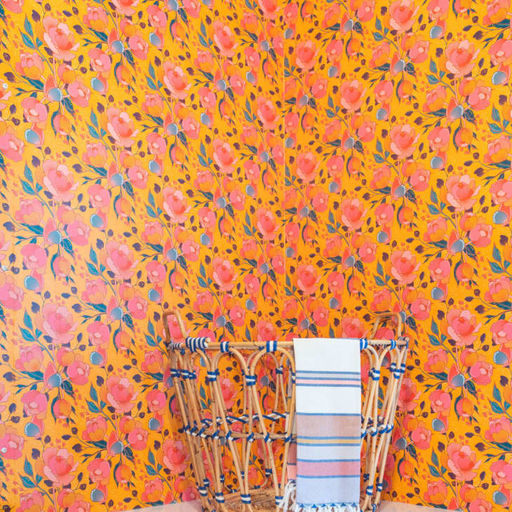 orange and pink floral wallpaper in a small mudroom