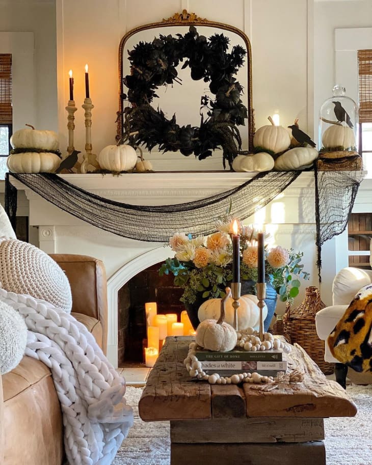 room decorate for halloween with netting, white pumpkins