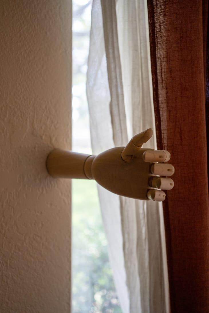 Wooden art mannequin hand used as curtain pull (Amanda Seyfried decor dupe)