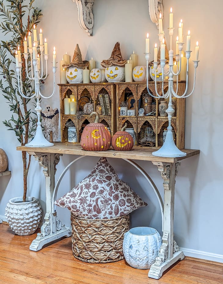 rustic-looking table and shelves decorated with halloween and vintage decor