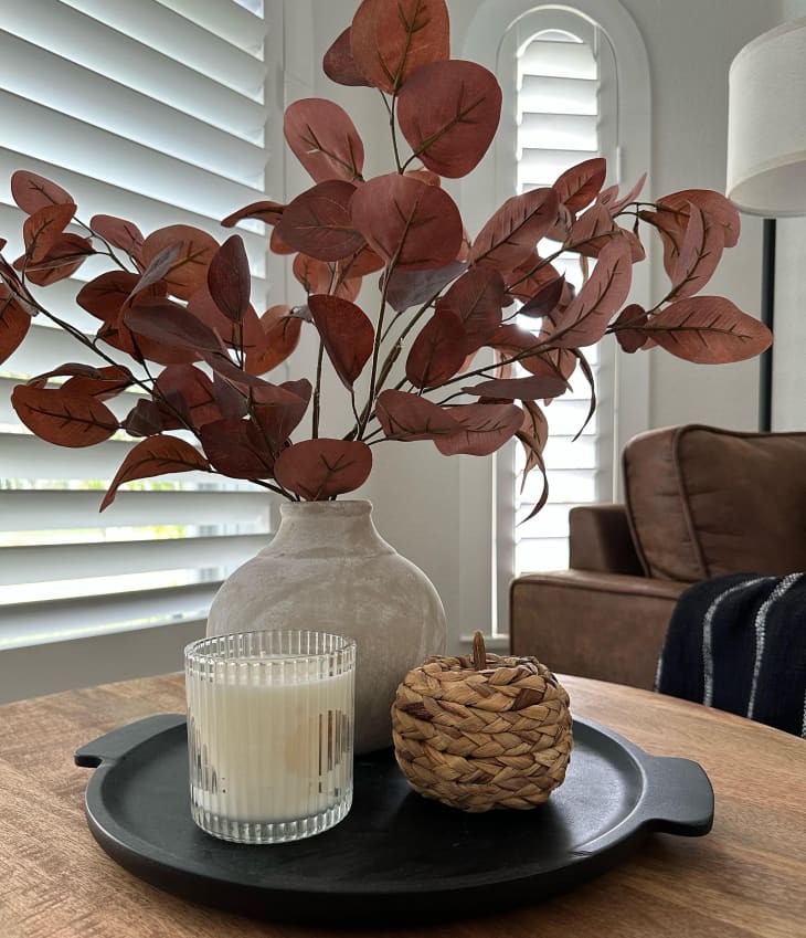 table with vase full of fall branches
