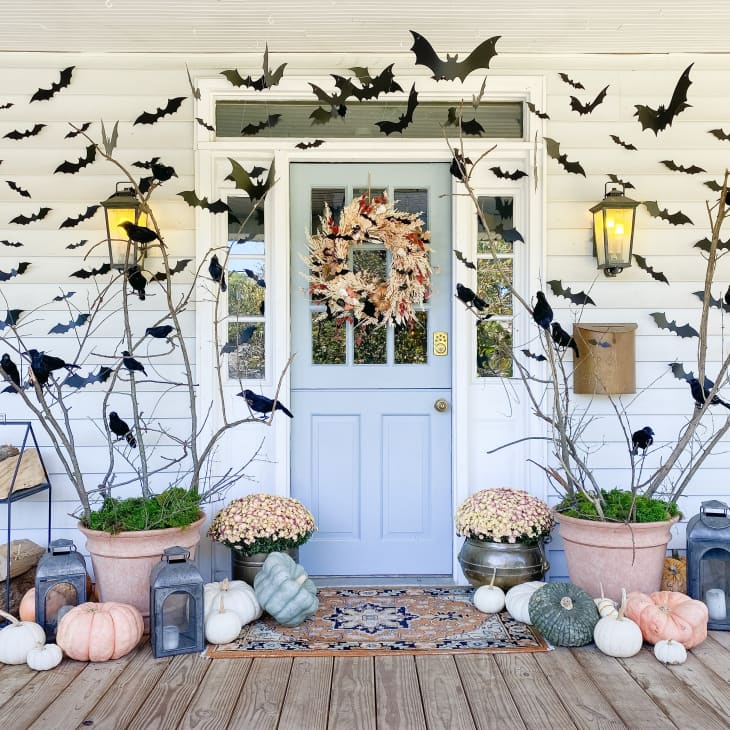 Porch and front door of home with bat and gourd decorations