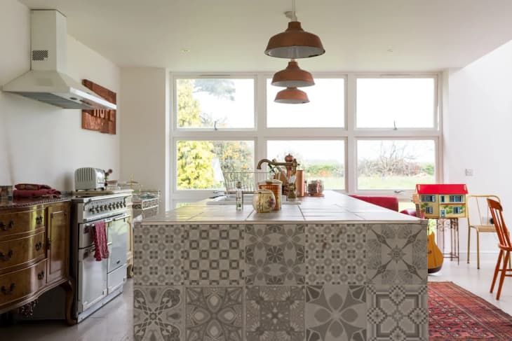 a kitchen island with patchwork tile on the sides