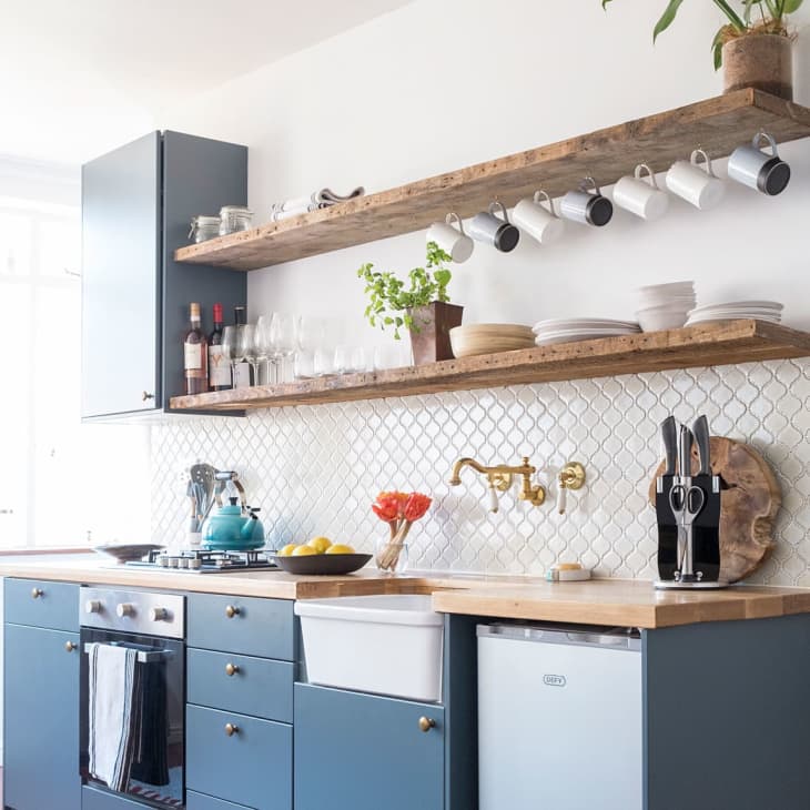 a kitchen with reclaimed wood open shelving