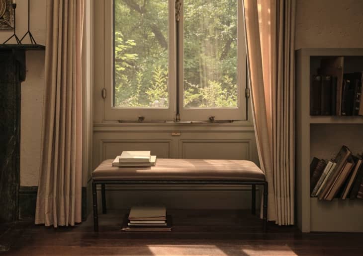 natural light, bench, beige curtains, books, molding, book shelf