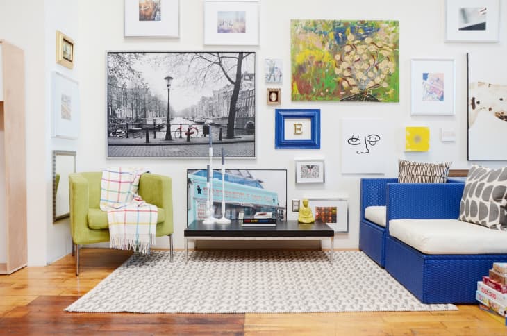 a living room with an eclectic gallery wall