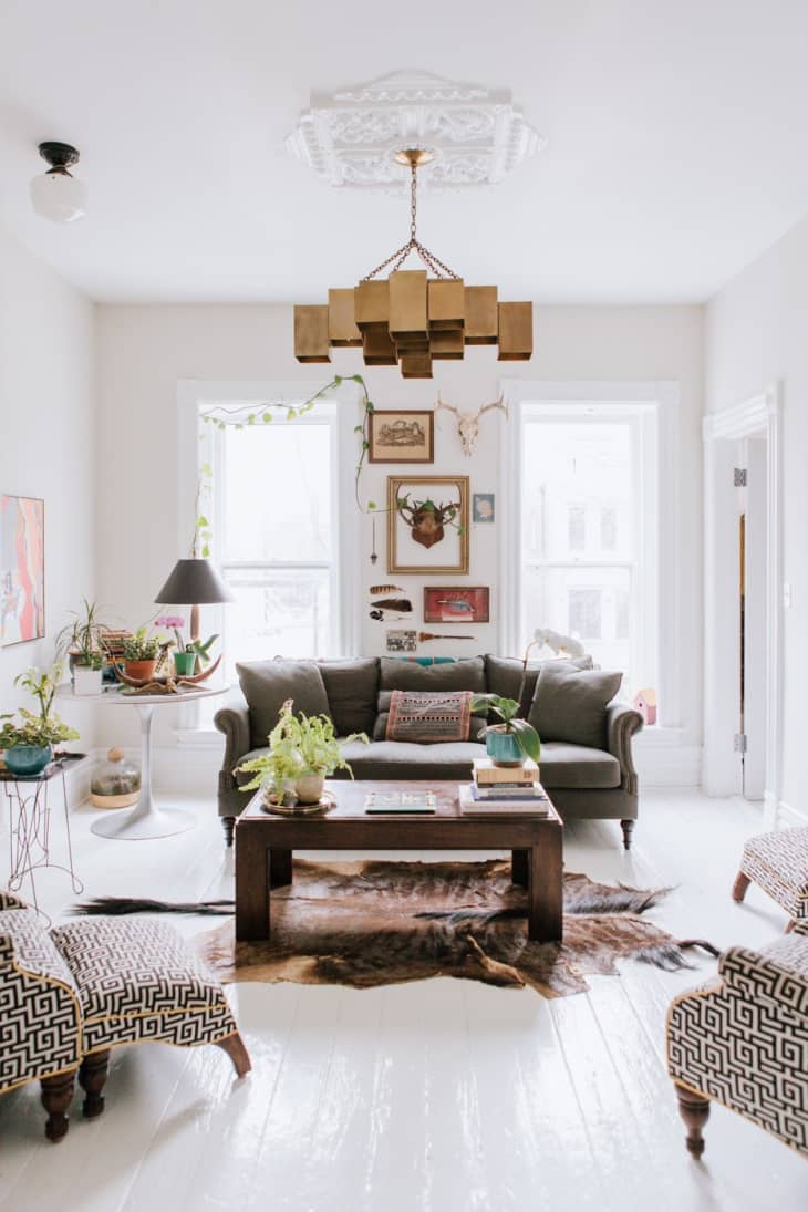 a white living room with a statement chandelier