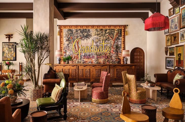 Lobby with lots of rich textured fabrics and a large tapestry sign at Graduate Palo Alto
