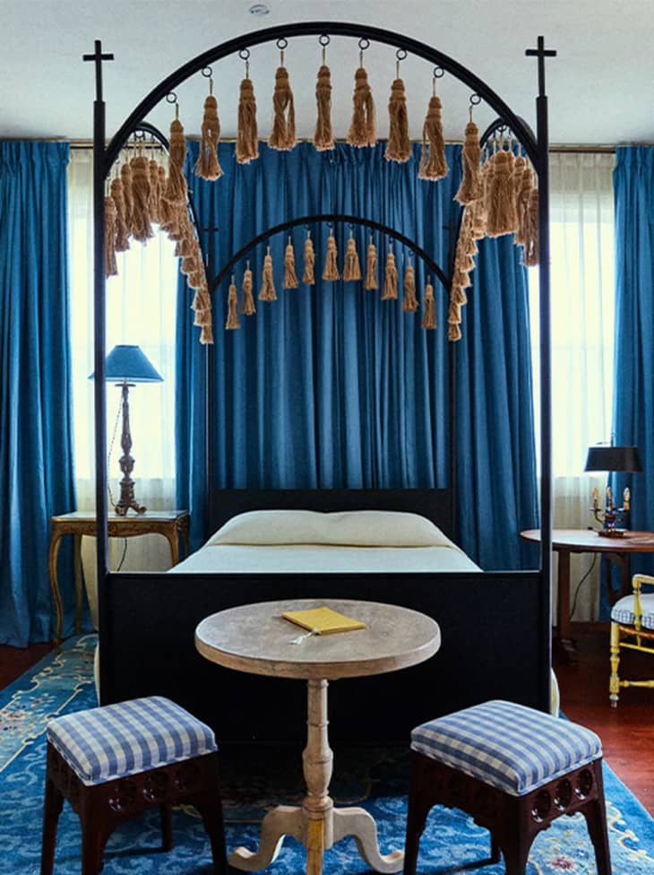 room with arched canopy bed and blue curtains, lamps, and rug at Hotel Peter &amp; Paul