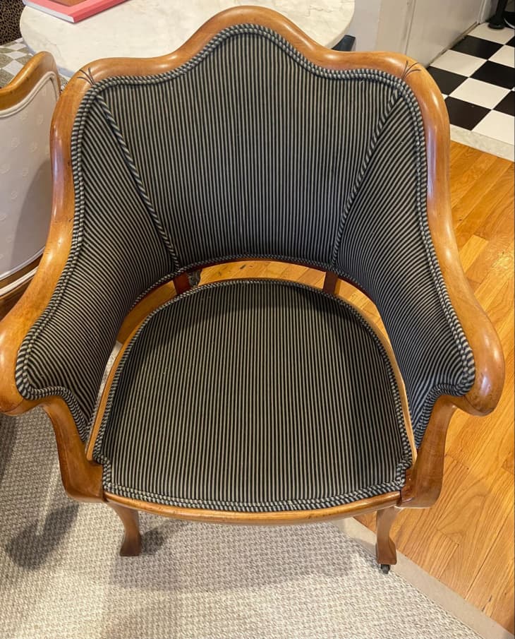 dark striped upholstery with wood frame on chair, curved arms and back