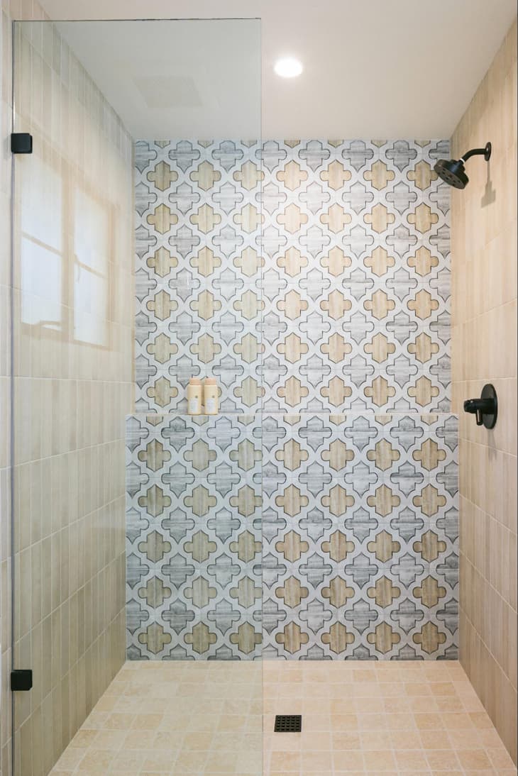 Grey and tan tiles in walk in shower.