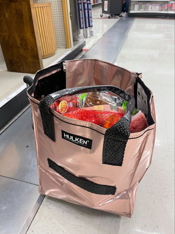 HULKEN Reusable Grocery Bag On Wheels on floor of store full of groceries