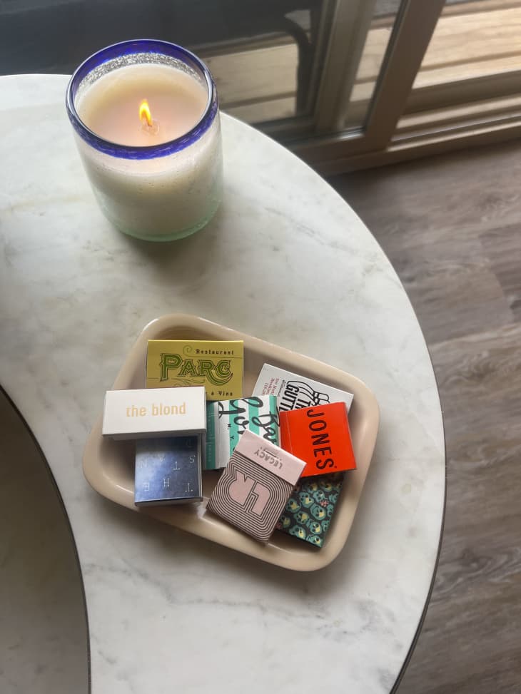 A matchbox collection on a stone table.