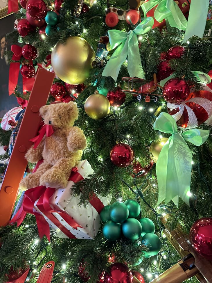 Christmas tree with lights, teddy bear and ribbon