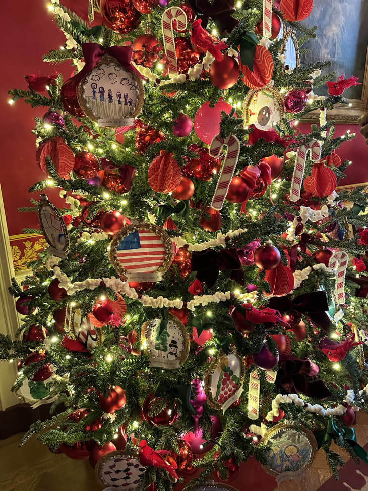 Red, gold and green Christmas tree with American flag and lights