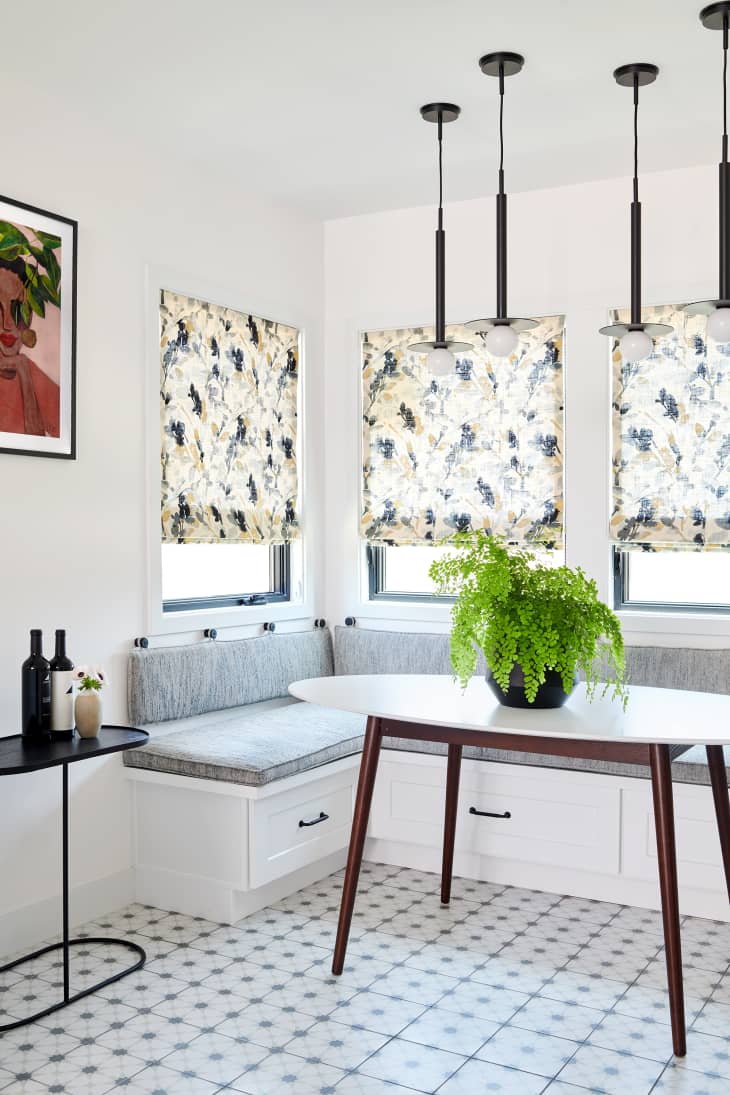 White breakfast nook area with botanical patterned window shades