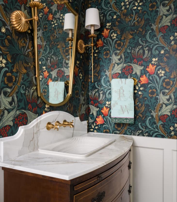 Bathroom with Floral wallpaper and sconces with fluted details