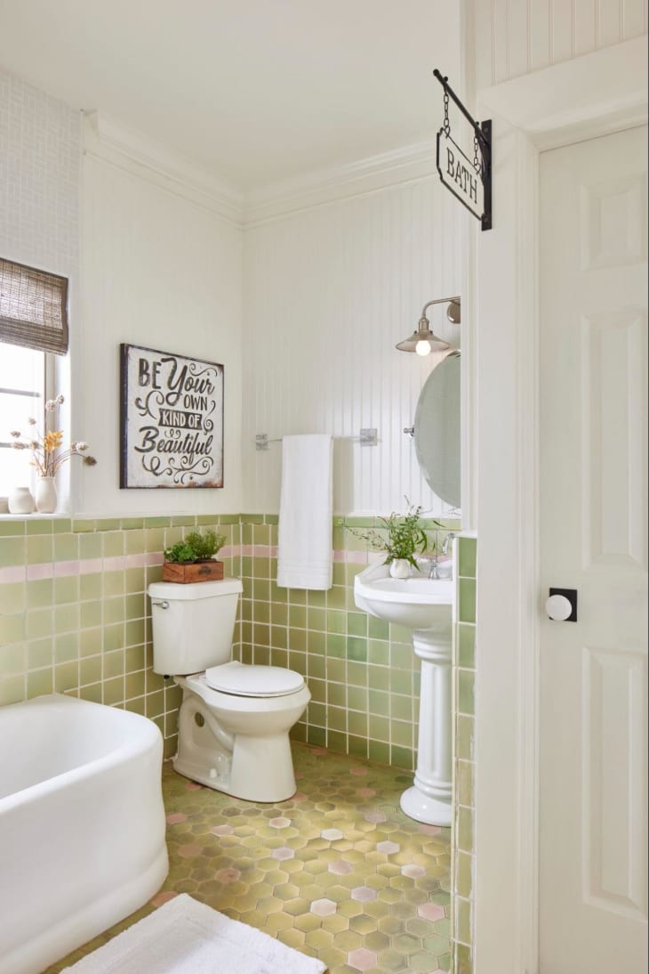 Green tile bathroom with white pedestal sink