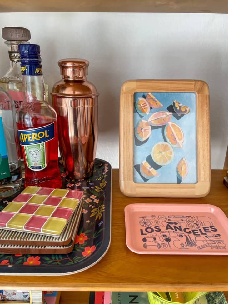 shelf with bar goods, decor and framed greeting card