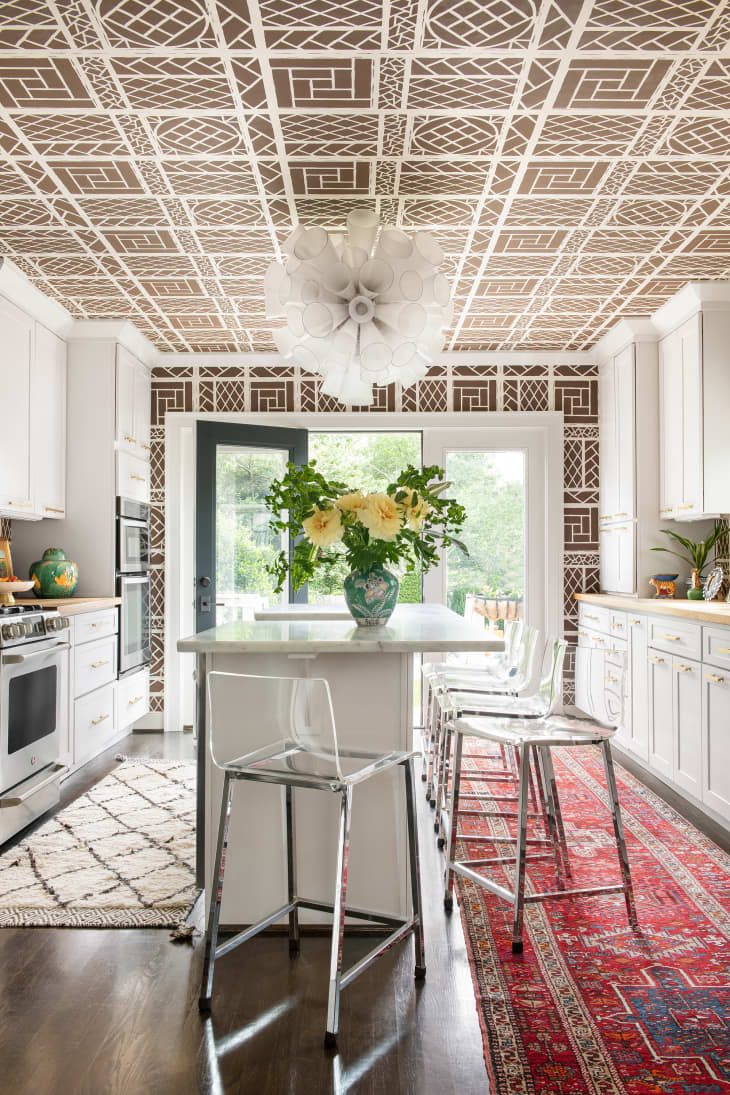 Kitchen with patterned wallpaper on ceiling and walls