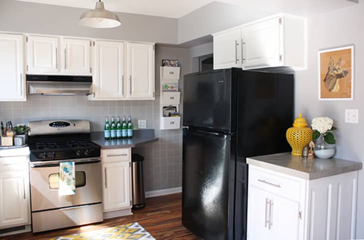 Gray kitchen walls with white deals cabinets