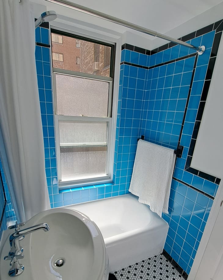 A Dated “Pinkish Beige” Bathroom Goes Bold, Blue, and Retro Apartment