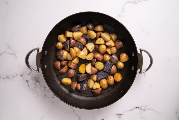 Potatoes roasting in black pan