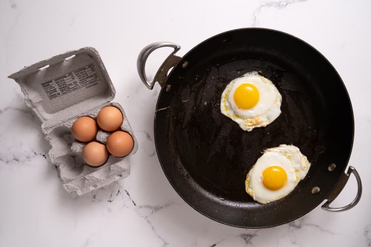 two fried eggs in black skillet