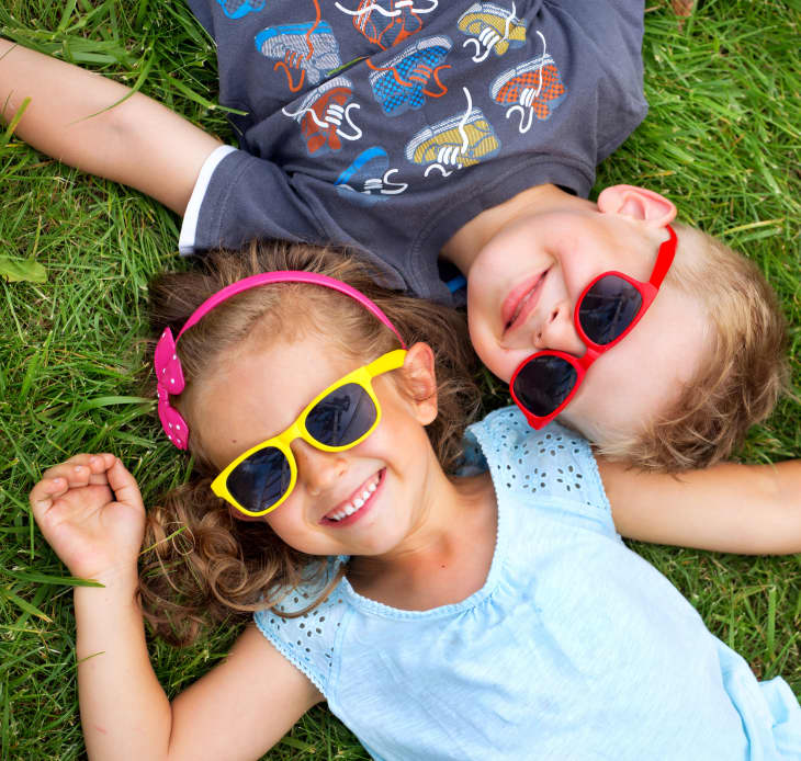 kids laying in the grass with sunglasses