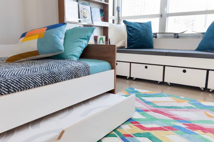 Trundle bed pulled out in multi-purpose kids room.