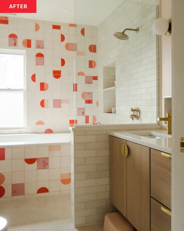 Colorful tiles in bathroom with wooden vanity after renovation.