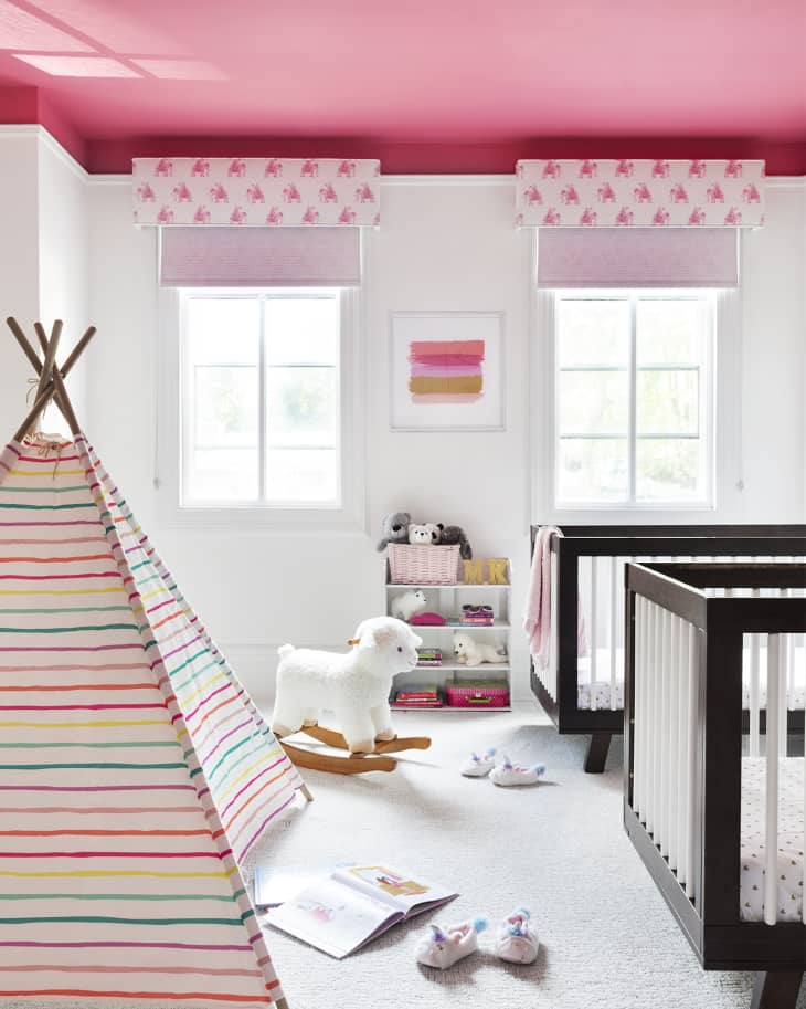 pink ceiling, rainbow striped t pee, black and white matching cribs