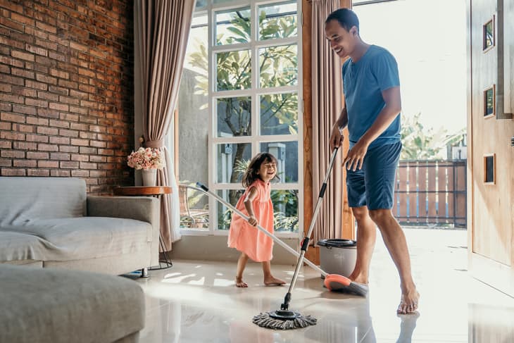 child helping dad clean in home