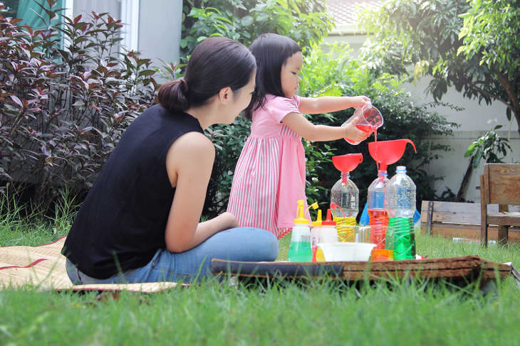 mom and child doing science project outdoors