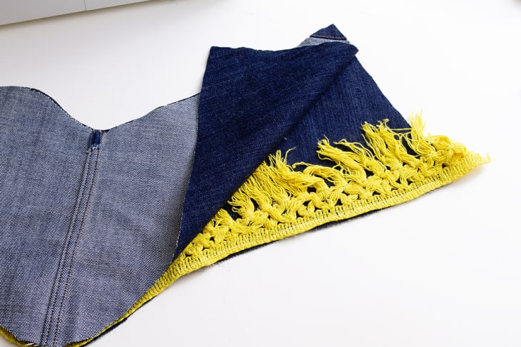 holiday stocking with yellow boho fringe sandwiched between two pieces of denim