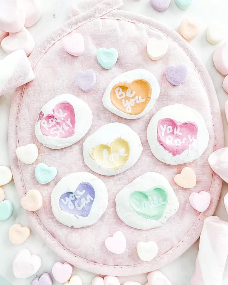 colorful heart print on white clay, resting on a pink plate with candy hearts