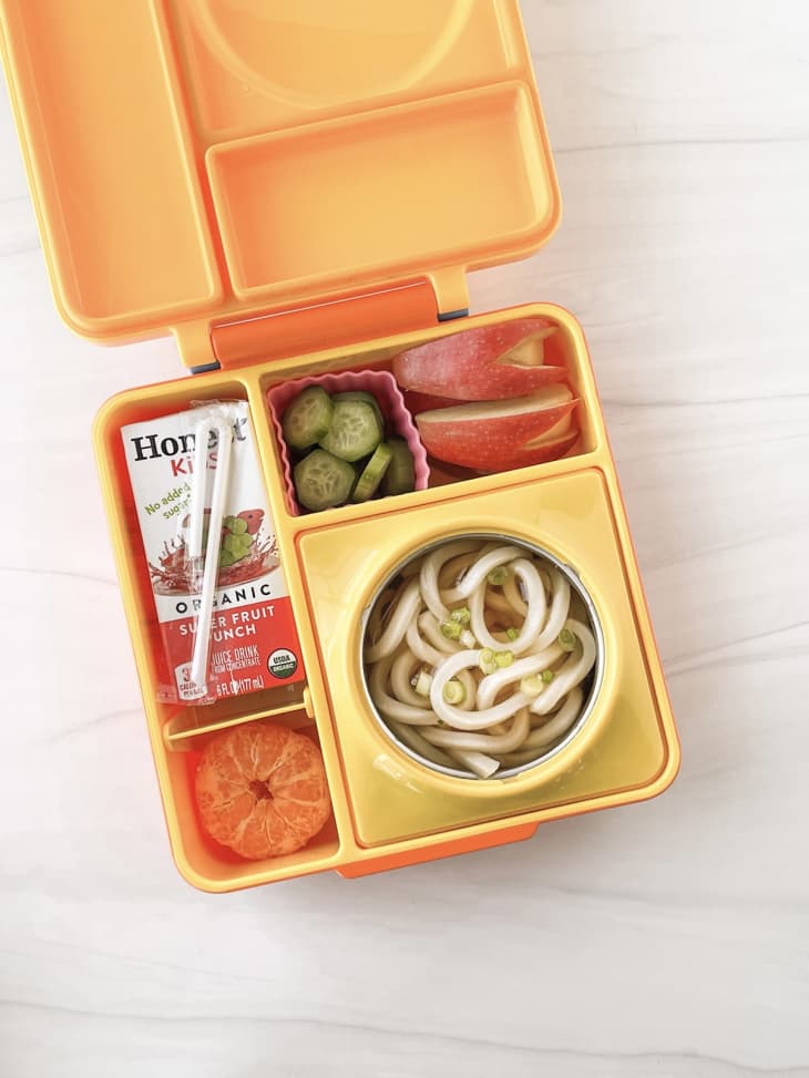 Udon, cucumbers, apples, tangerine, and a juicebox