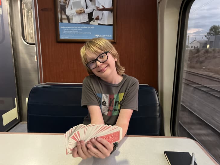 Boy holding cards on train