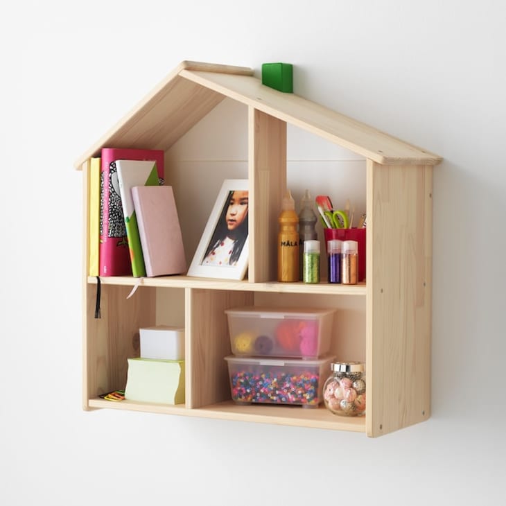 IKEA FLISAT wood dollhouse hanging on shelf with toys and books